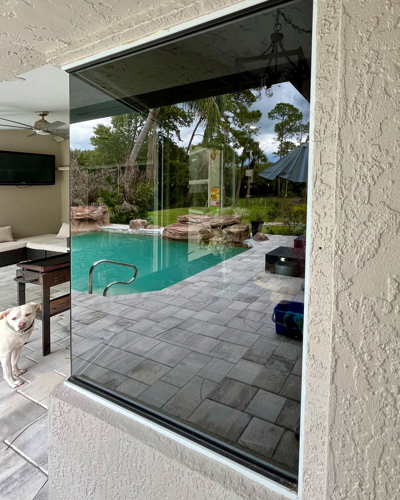 Large clean window overlooking a pool area